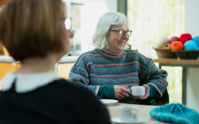 Woman in a knitting club enjoying a hot drink